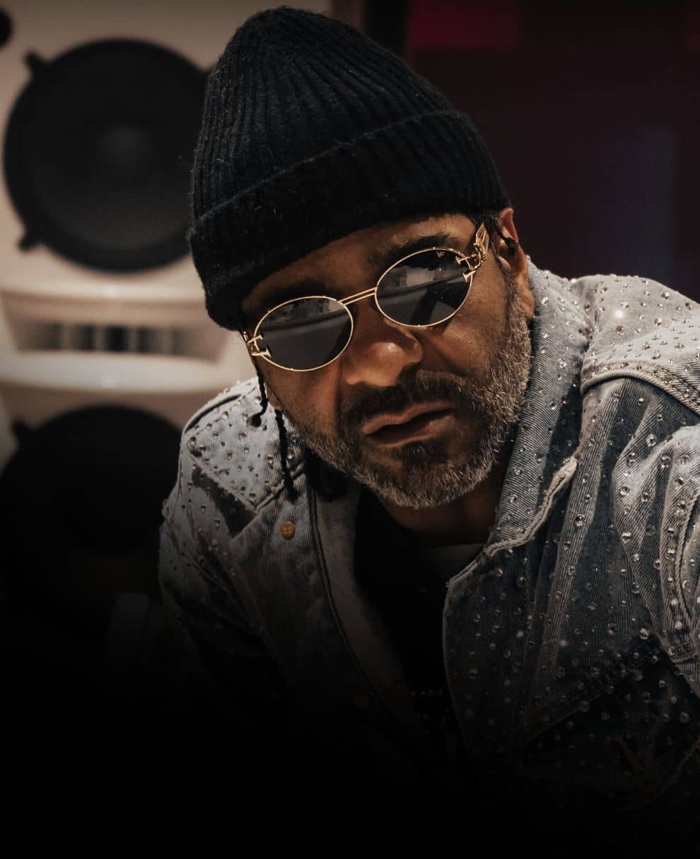 Jim Jones wearing sunglasses in studio close up